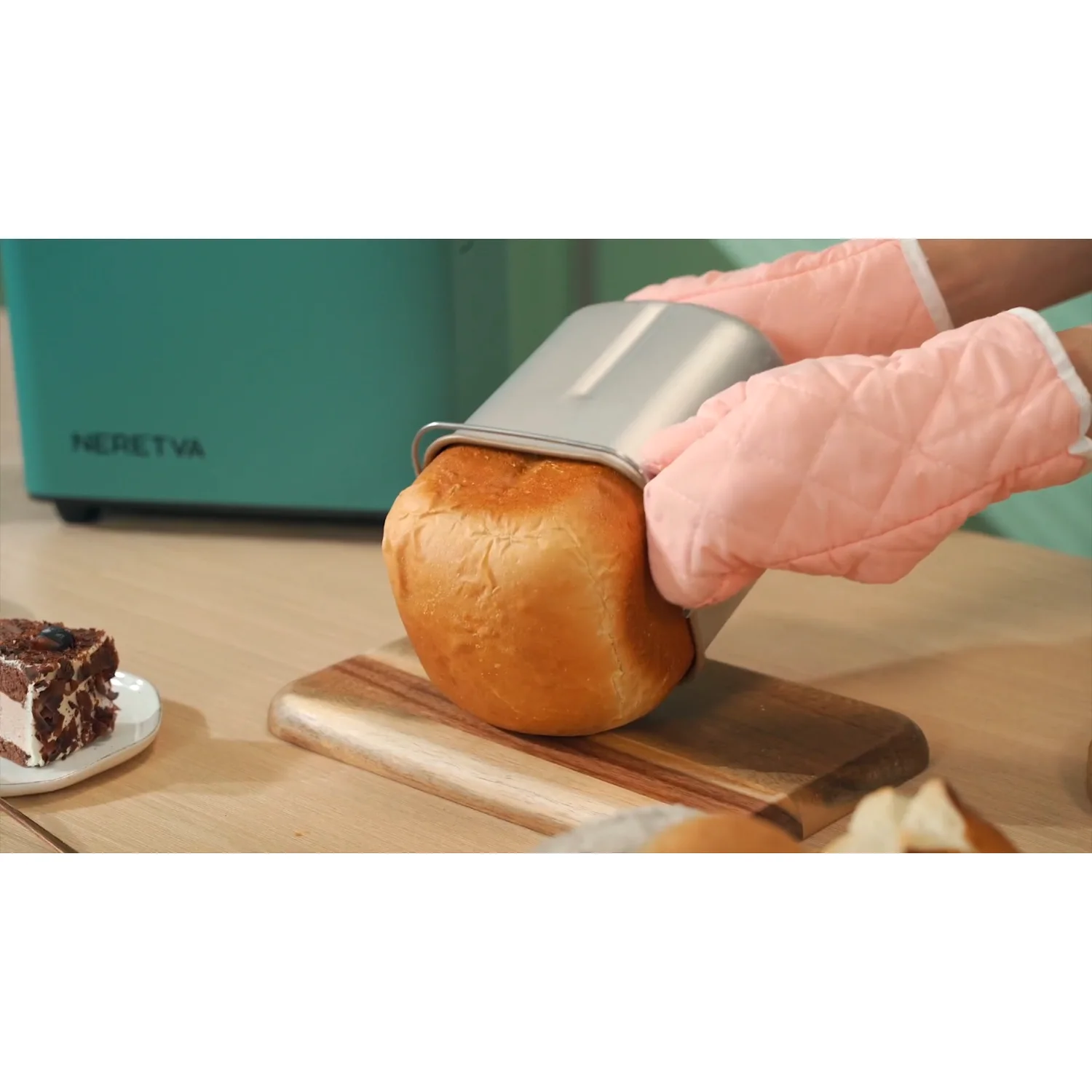 A finished loaf leaving the ceramic pan. A smooth pan and a paddle that still grips are most of the difference between a loaf that slides out and one that has to be dug out.